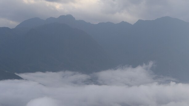 A mountain range with clouds at the base. -  Belle Maison Sapa Resort & Spa - Formerly Sapa Eco Villas & Spa (Ta Van)