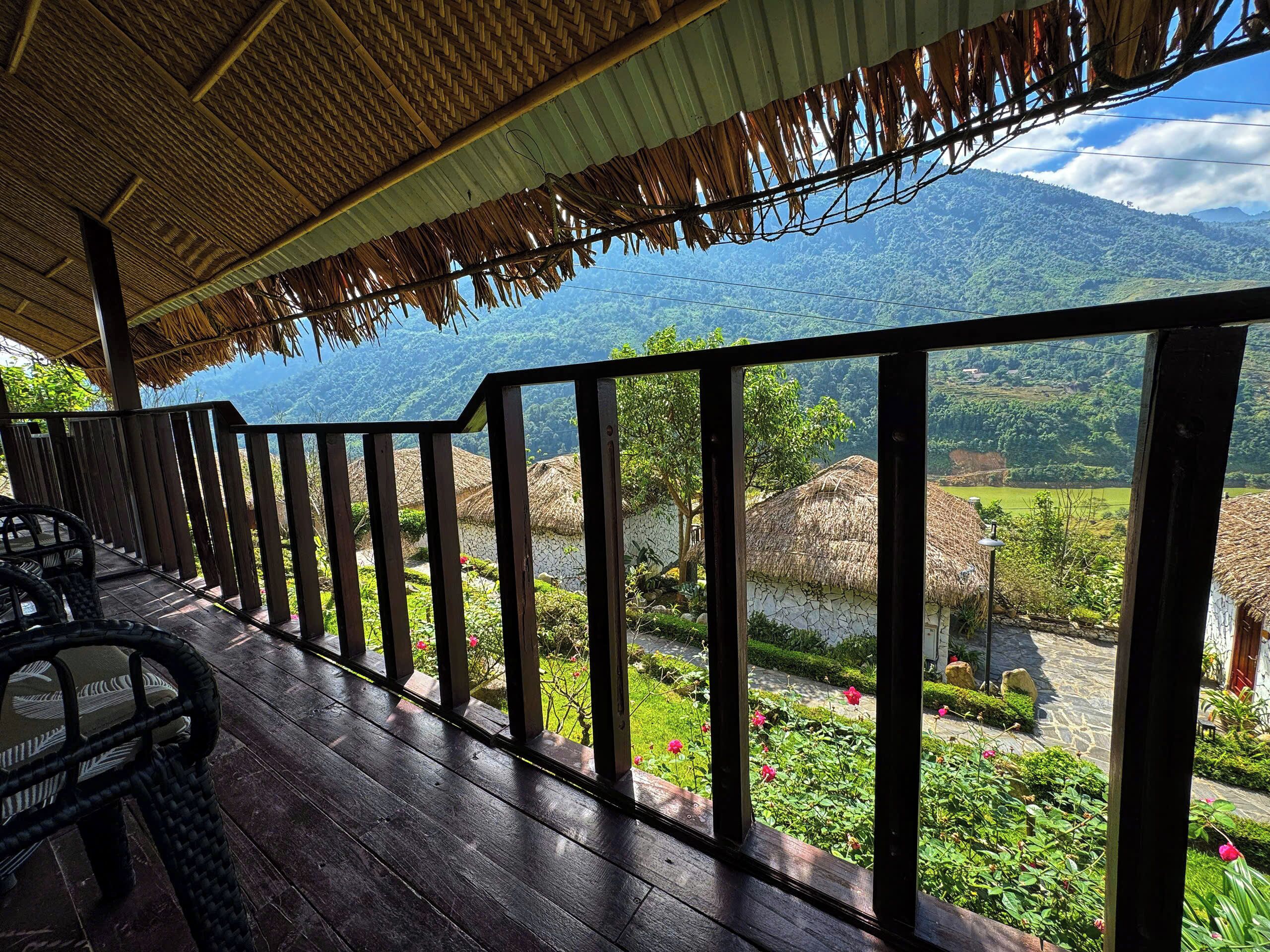 A wooden deck with a view of a mountainous landscape.