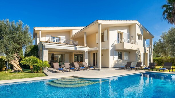 A two-story building with a swimming pool, lounge chairs, and a well-maintained garden. - Villa Can Monxo By SunVillas Mallorca (Port de Pollença)