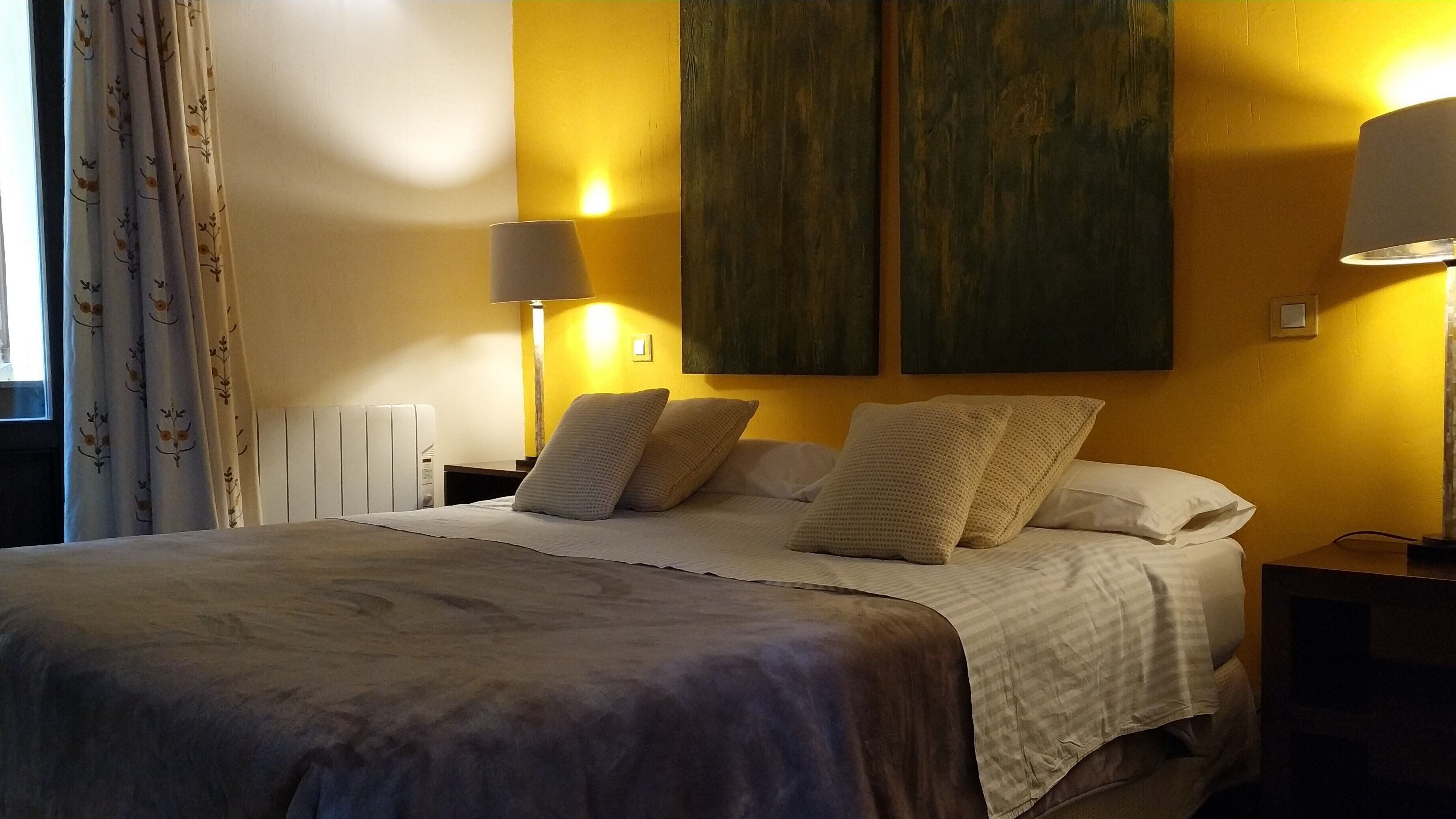 1 dormitorio y tabla de planchar con plancha