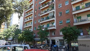 A multi-story residential building with balconies, some with plants. - Your Home @ ROME near TRASTEVERE (Roma)