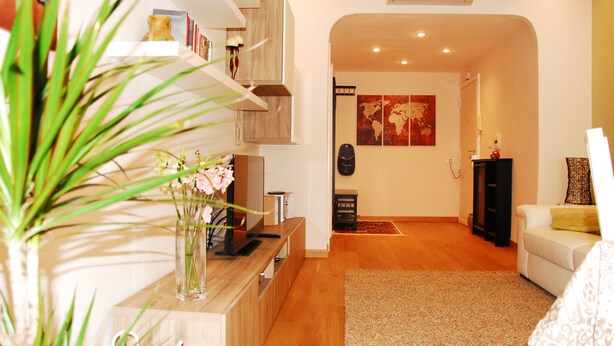 A modern living room with a wooden cabinet, a white sofa, a coffee table, and a bookshelf. - Your Home @ ROME near TRASTEVERE (Roma)