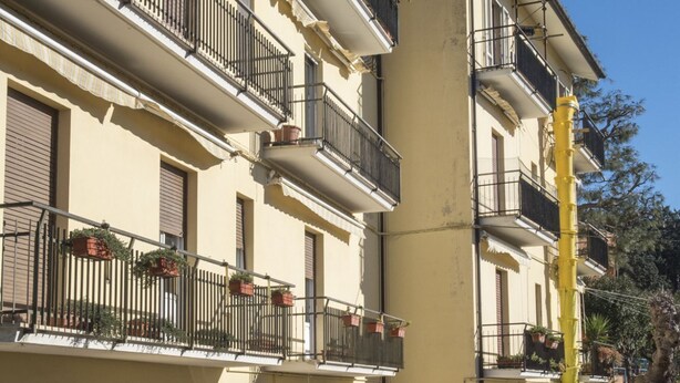A multi-story building with balconies, some with potted plants. - S034 - Sirolo, tastefully furnished four-room apartment in the center (Sirolo)