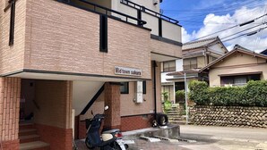 A two-story building with a sign reading "Mid town sakura."
