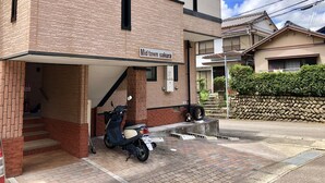 A two-story building with a sign reading "Mid town sakura". - Midtown Sakura Apartment House 101 (Nachikatsuura)