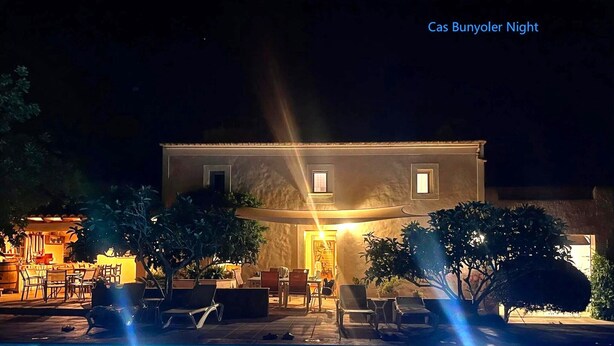 A nighttime view of a building with a pool, outdoor seating, and a well-lit entrance. - Cas Bunyoler - In Cas Concos, Felanitx, with private swimming pool, AC bedrooms (Cas Concos des Cavaller)