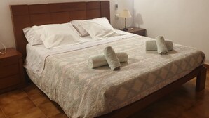 A neatly made bed with a patterned bedspread and two rolled towels. - Cas Bunyoler - In Cas Concos, Felanitx, with private swimming pool, AC bedrooms (Cas Concos des Cavaller)