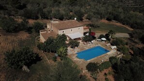 An aerial view of a house with a swimming pool, surrounded by trees and a hilly landscape. - Cas Bunyoler - In Cas Concos, Felanitx, with private swimming pool, AC bedrooms (Cas Concos des Cavaller)