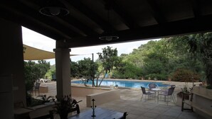 An outdoor patio area with a pool, seating, and potted plants. - Cas Bunyoler - In Cas Concos, Felanitx, with private swimming pool, AC bedrooms (Cas Concos des Cavaller)