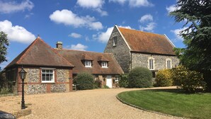 A stone building with a gravel driveway and a lawn. - Well Cottage, a one bedroom self-catering holiday cottage all on one level. (Kent)