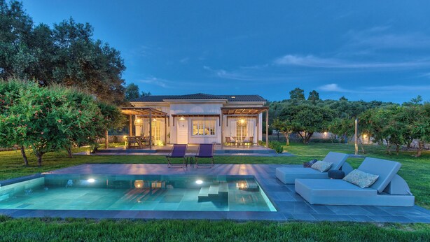 A modern house with a swimming pool, outdoor seating, and a well-maintained garden. - Classic Three Bedroom Cottage with private pool (Zakynthos)