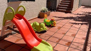 A children's play area with a slide, a toy car, and a small green vehicle. - Villa Anna with Pool and panoramic terrace. (Costa Saracena - Castelluccio)