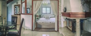 A bedroom with a bed, a glass table, chairs, a mirror, and a fireplace. - Apartment"View Lux"-sea view,swimming pool, jacyzzi, sauna,garden,playground (Vela Luka)