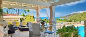 An outdoor patio with seating, a pool, and a view of the sea. - Apartment"View Lux"-sea view,swimming pool, jacyzzi, sauna,garden,playground (Vela Luka)