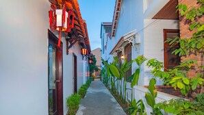 A narrow alleyway with traditional architecture, including wooden facades and red lanterns. - Green Grapefruit Villa (Da Nang)