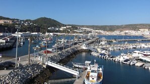 A marina with boats docked, a bridge, and buildings in the background. - Villa with large pool, mountain&ocean view-near beaches&Lisbon  (Sesimbra)