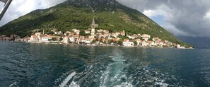 A coastal town with a prominent church on a hill, surrounded by buildings with red-tiled roofs, and a body of water in the foreground. - B unit, One bedroom, Stunning views, waterfront, free secured parking (Lipci)