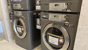 Two commercial washing machines with digital displays and control panels, placed in a tiled area. - Toyoko Inn Seoul Dongdaemun No.2 (Seoul)