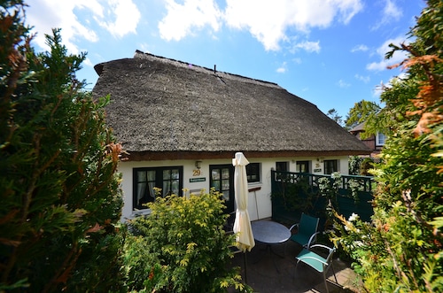 Historical Thatched with a separate entrance with transom windows and shutters