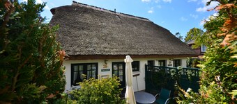 Historical Thatched with a separate entrance with transom windows and shutters