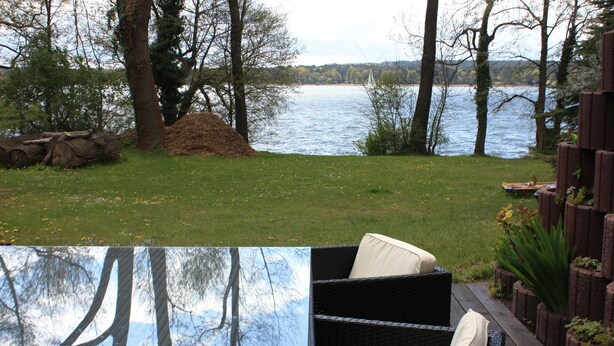 A patio with wicker furniture and a view of a lake.