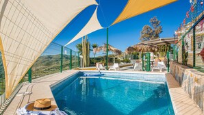 A swimming pool with a clear view of the surrounding landscape, including trees and a distant mountain. - Lovely home in Tallante (Tallante)