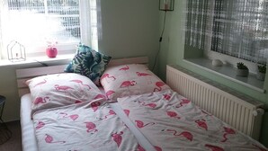 A bedroom with a bed, a window with a view, and a radiator. - Holiday house, Martha``am Szczecin Lagoon / Meck / Pom / Ueckermünde-Bellin (Ueckermünde)