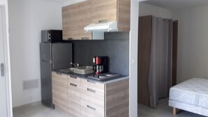 A compact kitchen with modern appliances, a built-in microwave, and a coffee maker. - LAST MINUTE Studio N ° 5 BC (Cavalaire-sur-Mer)