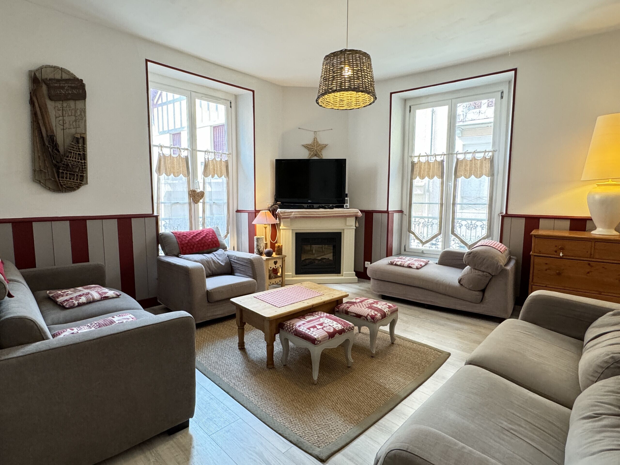 A living room with a fireplace, two sofas, a coffee table, and a television.