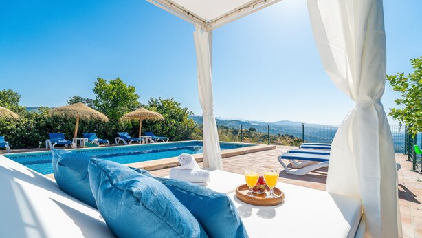 A poolside lounge with a view of the pool, blue lounge chairs, and a breakfast tray with drinks. - Beautiful Villa Botin, 9 Pers, Heated pool, Wifi, BBQ,Petfriendly, magnific view (Comares)
