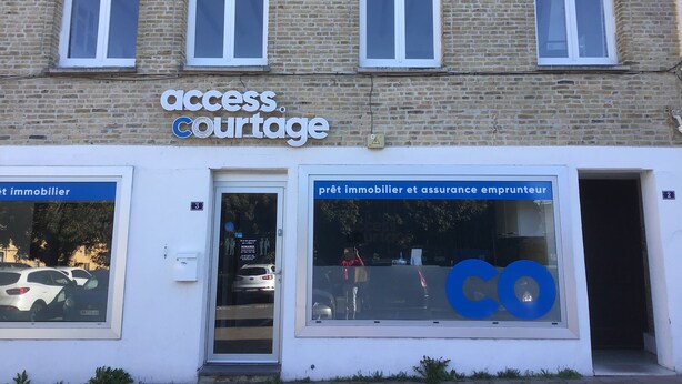 A building with a sign reading "Access Courtage" and another sign for "immobilier et assurance emprunteur". - Apartment hyper center of Saint Omer (Saint-Omer)
