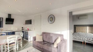 A modern apartment with a kitchen, dining area, and a bedroom. - Beautiful holiday home, charm and rest. Seaview! (Viggianello)