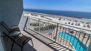 A balcony with a pool and a view of the beach. - Shore to Please beach lovers paradise! (New Smyrna Beach)