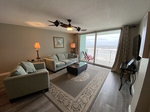 Relax in comfort with a plush sofa, coffee table, and ocean views.