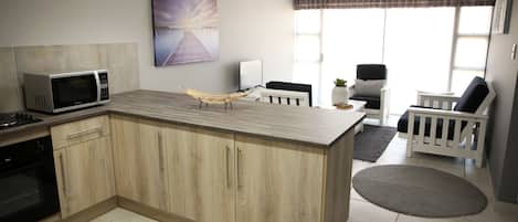 Full-size fridge, microwave, stovetop, electric kettle