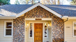 A house with a stone facade and a wooden front door.