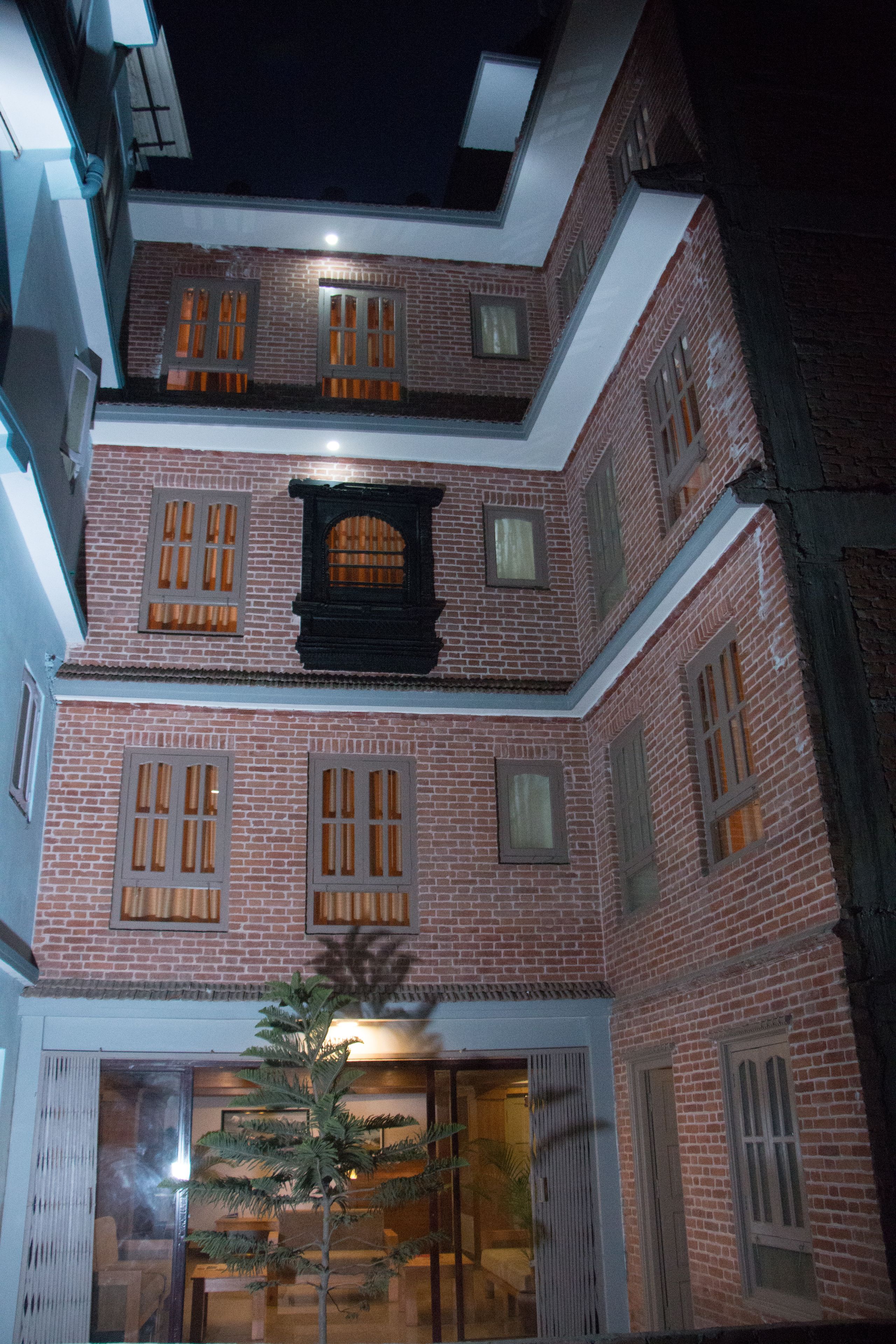 A multi-story building with brick walls and multiple windows.