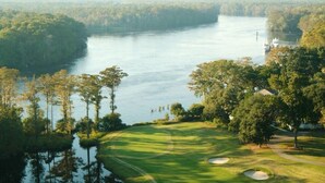 A golf course with a water body, trees, and a clear sky. - Murrells Inlet, SC , Wachesaw Plantation, SC , 2 bed Condo (Murrells Inlet)