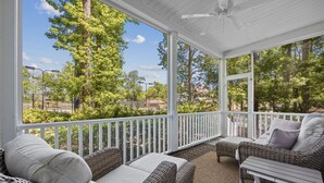 A covered porch with wicker furniture and a view of trees and buildings. - Murrells Inlet, SC , Wachesaw Plantation, SC , 2 bed Condo (Murrells Inlet)