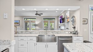 A modern kitchen with white cabinetry, a stainless steel sink, and a built-in dishwasher. - Murrells Inlet, SC , Wachesaw Plantation, SC , 2 bed Condo (Murrells Inlet)