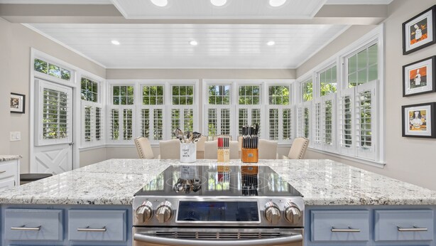 A spacious kitchen with a large island, white cabinetry, and a view through large windows. - Murrells Inlet, SC , Wachesaw Plantation, SC , 2 bed Condo (Murrells Inlet)
