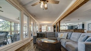 A spacious living room with a large sectional sofa, a wooden coffee table, and a ceiling fan. - Lake Chillin’ at its finest! (Shelby County)