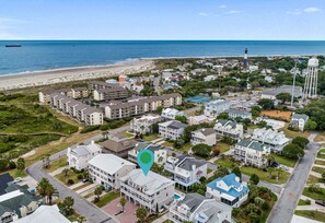 Enjoy stunning views of the beach and surrounding green spaces from this coastal neighborhood.