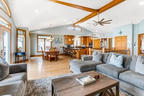 Relax in this airy living space with a high ceiling and comfortable seating area.