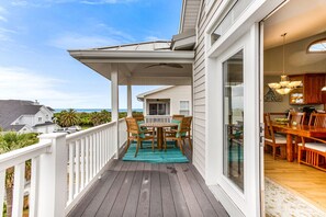 Enjoy meals on the covered patio with a view of the ocean.
