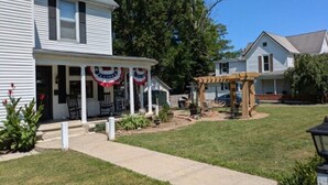 A residential house with a front porch, a covered patio, and a well-maintained lawn. - The Gate House (Entire House) (Lancaster)