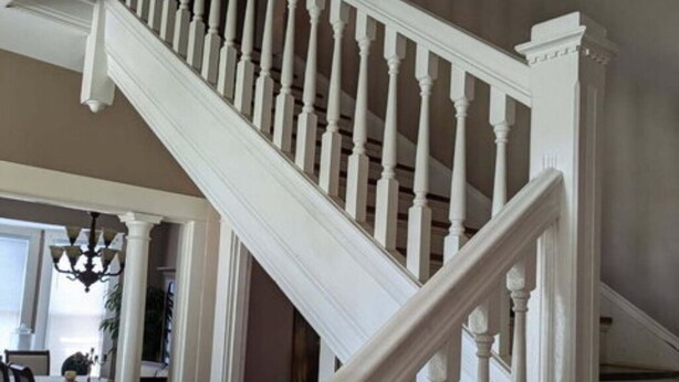 A staircase with white balusters and a handrail, leading to an upper floor. - The Gate House (Entire House) (Lancaster)
