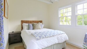 A bedroom with a bed, a nightstand, a window, and a door. - Baytree Cottage | Beautiful Stay w/ Amazing Views (Inverness)
