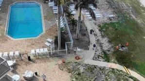 A hotel with a pool, beach access, and a view of the ocean.