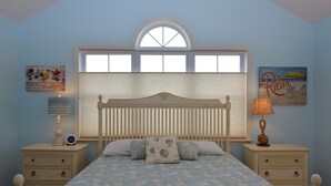A bedroom with a bed, two nightstands, a window with blinds, and wall art. - Rehoboth Beach Condo Elevator Pool Parking Clean (Rehoboth Beach)